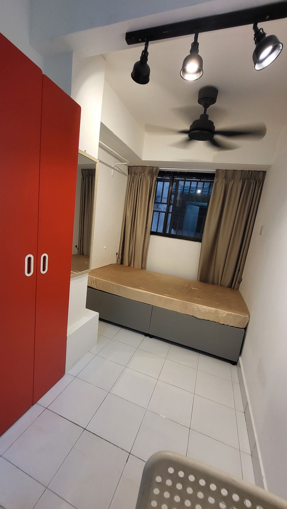Renovated room with track lights and ceiling fan